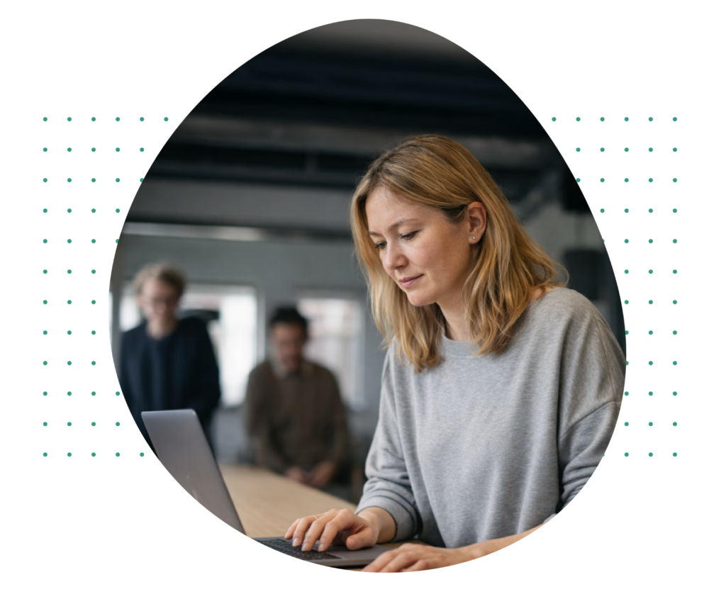 Woman working at laptop in office.